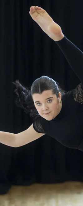 Dancer stretching one leg high along the ballet barre, demonstrating strength and flexibility. Dancer stretching one leg high along the ballet barre, demonstrating strength and flexibility.